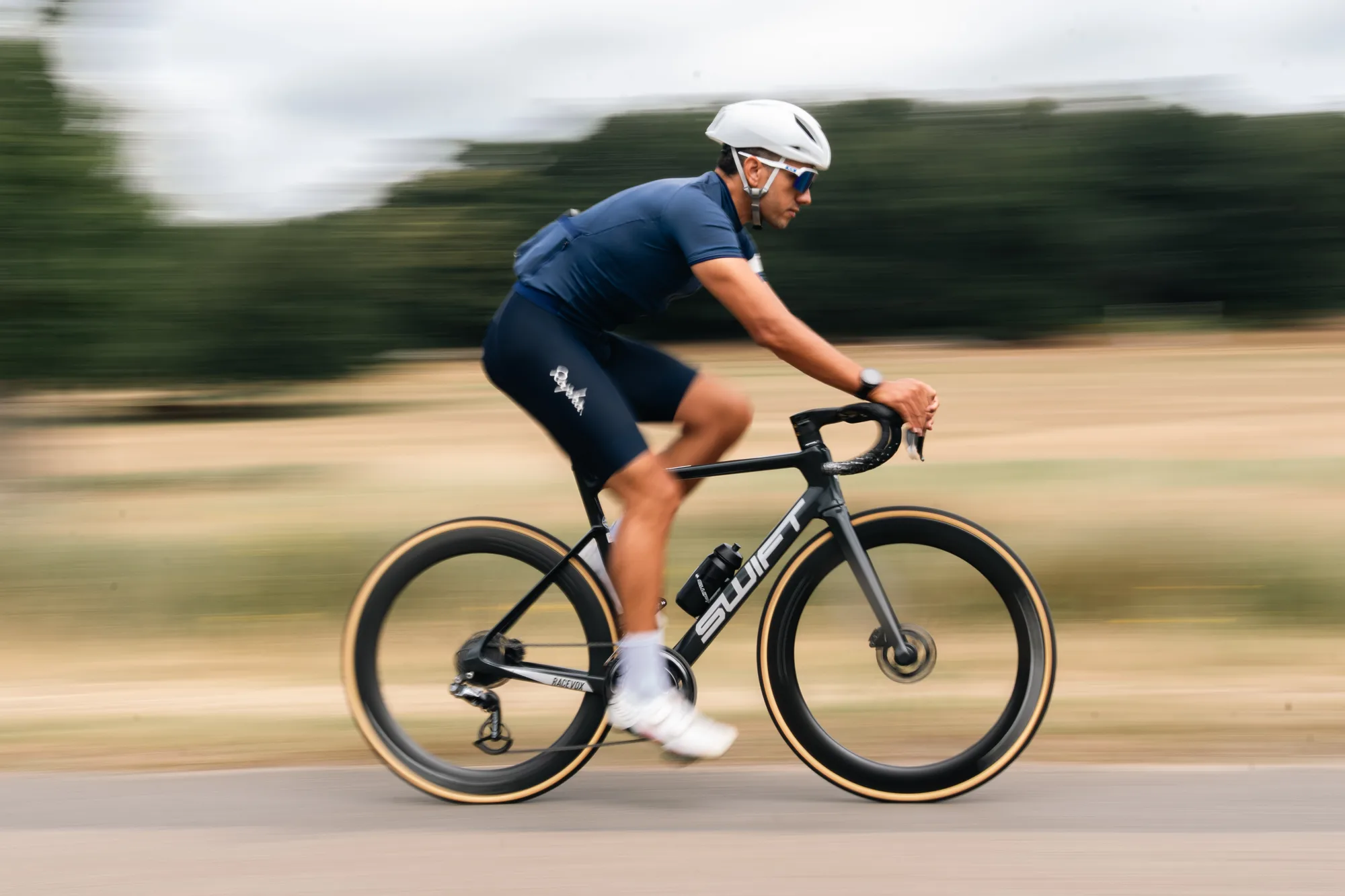 A rider at full speed, the background pulled into horizontal streaks by the long-lens pan