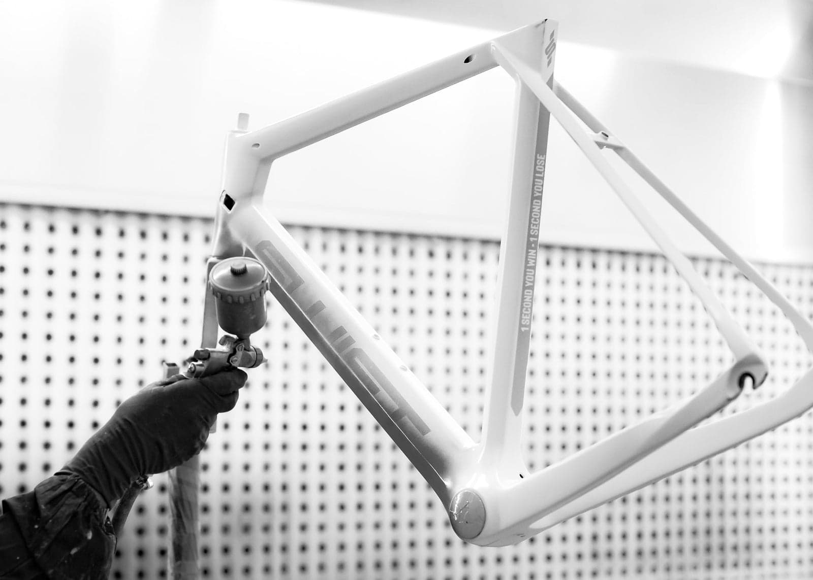 A Swift frame in the paint booth, the bold saturated colourway a brand signature